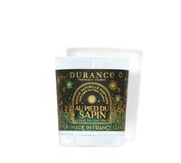 Petite bougie parfumée au pied du sapin