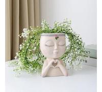 Pot de fleurs Famanu, idéal pour l'intérieur et l'extérieur, représentant une petite fille aux yeux fermés et orné d'un symbole de cœur