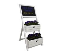 Présentoir à fleurs blanc en forme de cœur avec un tableau noir